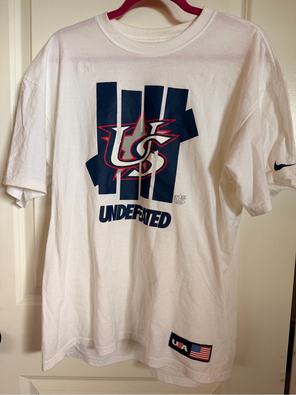Nike White Short Sleeve Undefeated Graphic Tee with Navy & Red Logo